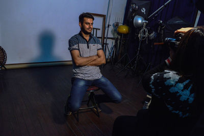 Young man sitting on seat