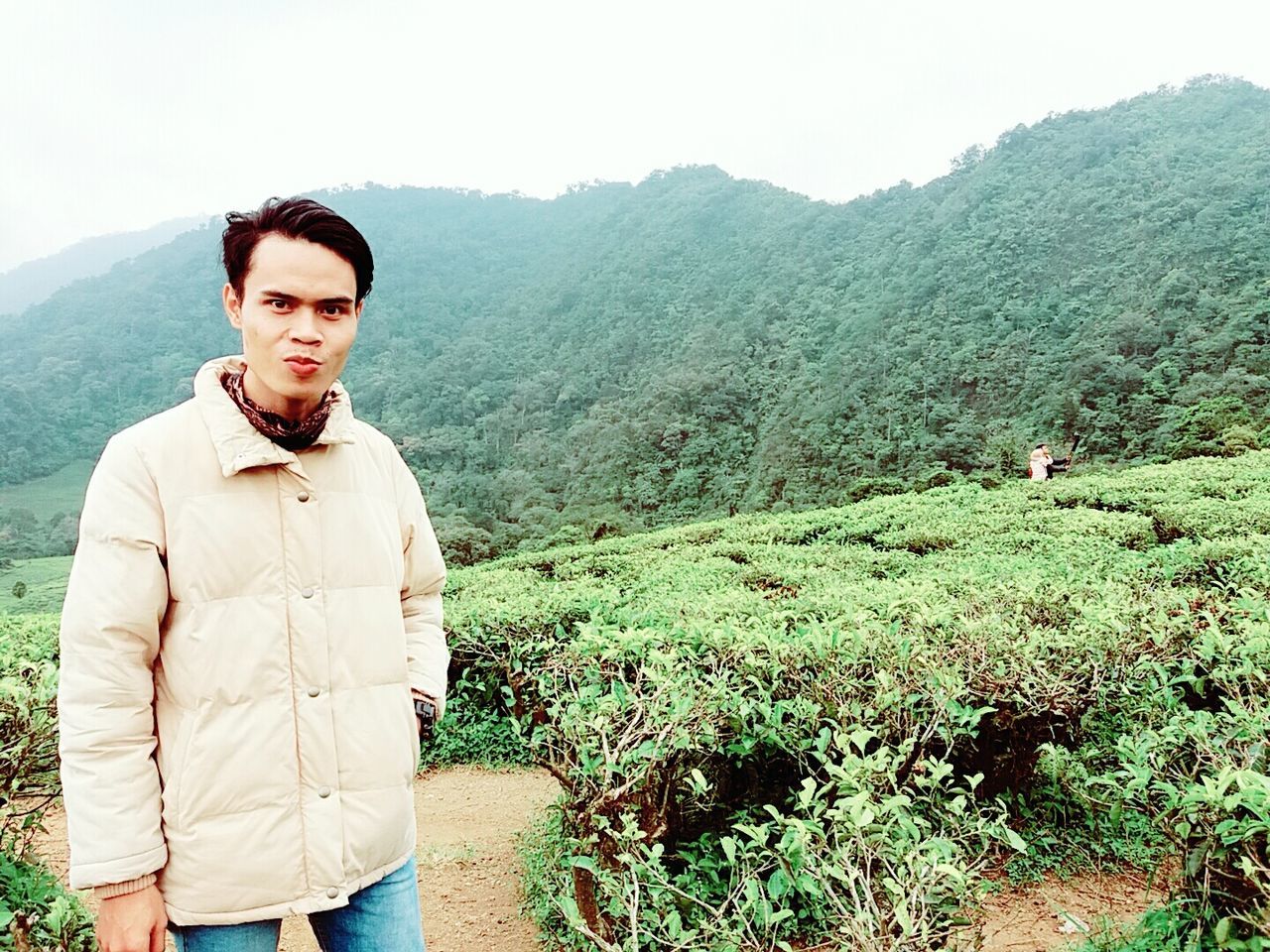 mountain, lifestyles, young adult, leisure activity, casual clothing, young men, standing, three quarter length, person, portrait, looking at camera, front view, mountain range, smiling, hiking, clear sky, men