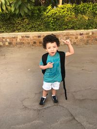 Full length portrait of boy standing on road