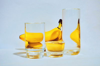 Close-up of yellow served on table against white background