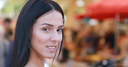 Close-up portrait of a smiling young woman