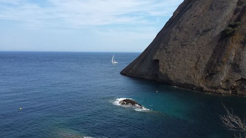 Boat sailing on sea against sky