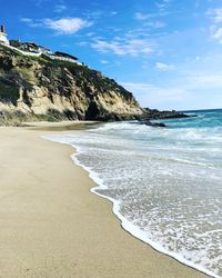 Scenic view of beach against blue sky