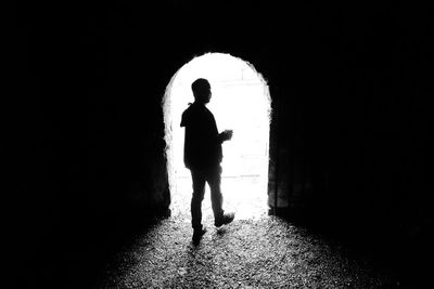 Full length of silhouette man walking in corridor