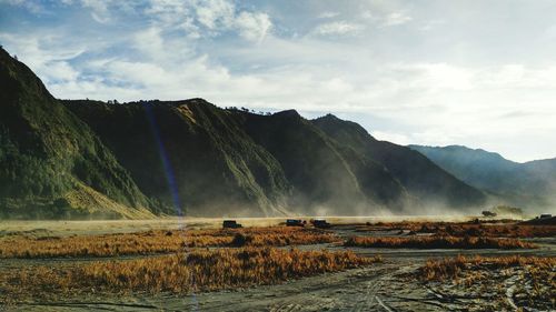 Scenic view of mountains against cloudy sky