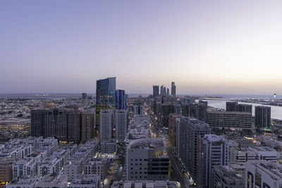 High angle view of modern buildings against sky during sunset