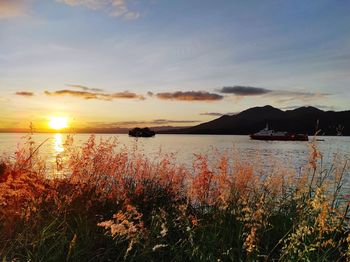 Scenic view of lake against sky during sunset