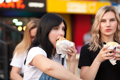 Portrait of young woman eating food