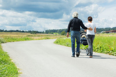 Rear view of women walking on road