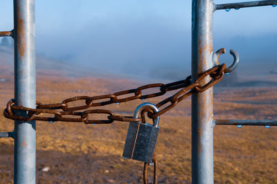 Close-up of padlock on metal railing