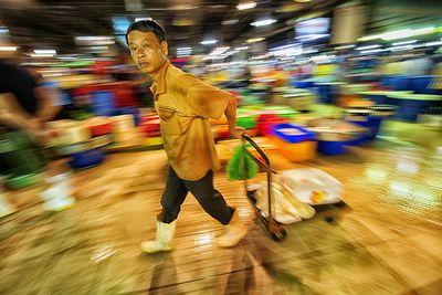 Blurred motion of man with umbrella at night