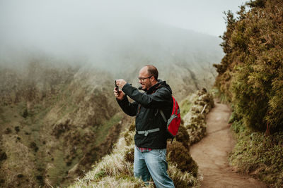 Man photographing on mountain