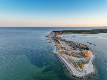 An aerial shot of the beach huts and sunset at mudeford spit in dorset