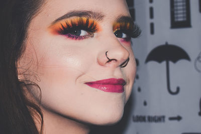 Close-up portrait of young woman wearing make-up