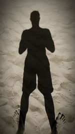 Shadow of man on sand at beach