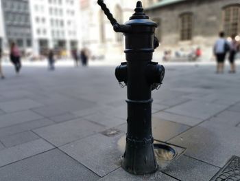Close-up of fire hydrant on sidewalk in city