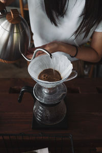 Barista dripping coffee and slow coffee wooden bar style