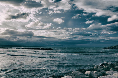 Scenic view of sea against cloudy sky