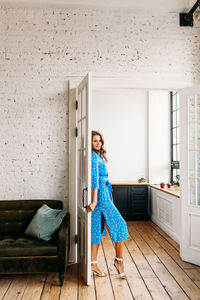 Portrait of woman standing on chair at home