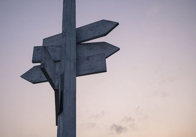 Low angle view of cross against sky