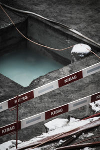High angle view of information sign on snow