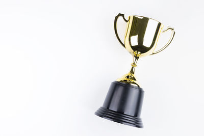 Close-up of trophy against white background