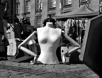 Rear view of woman sitting on street