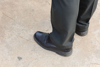 Low section of man standing on footpath