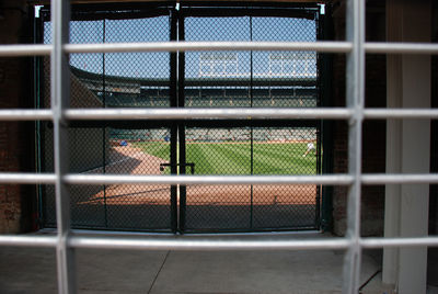 Close-up of fence seen through window