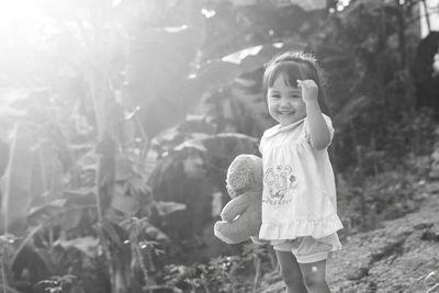 Portrait of cute smiling baby girl standing outdoors