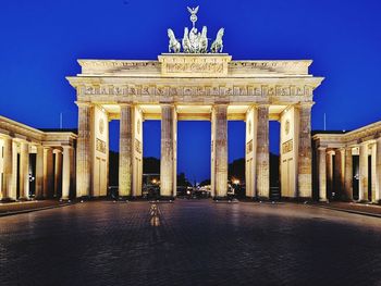 Statue in city at night