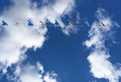 Low angle view of airshow against blue sky