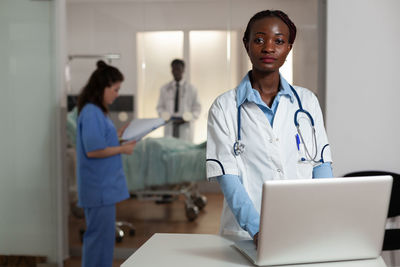 Portrait of doctor using digital tablet at clinic