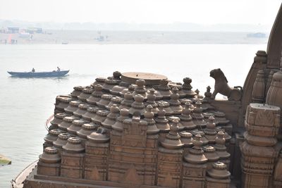 Stack of boats in sea against sky