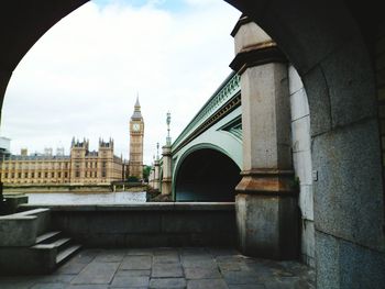 Big ben seen through bridge against sky