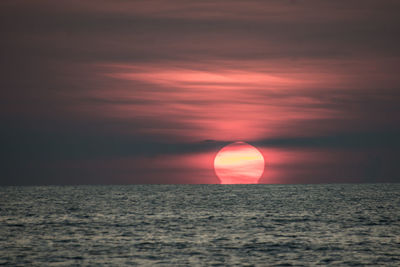 Scenic view of sea against romantic sky at sunset
