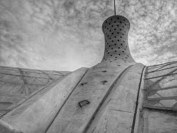 Low angle view of building against cloudy sky