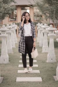 Full length of young woman standing in park