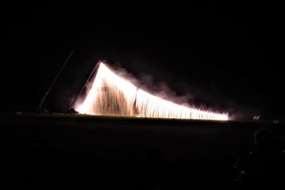 Illuminated city against sky at night