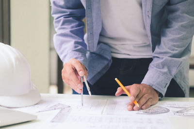 Midsection of man working on table