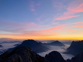 Scenic view of silhouette mountains against sky during sunset
