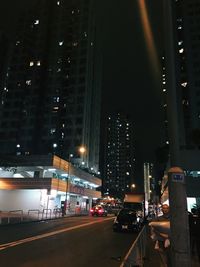 Illuminated city street and buildings at night