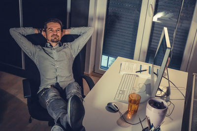 Businessman relaxing at desk in office