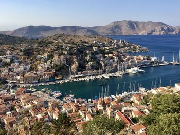 Symi island panoramic view from the top of hill. marina, yachts, colourful houses, mountain.