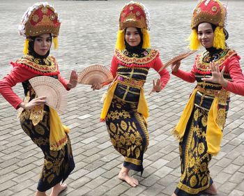 Gandrung dancers portrait of smiling friends standing on street