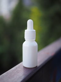Close-up of white bottle on table