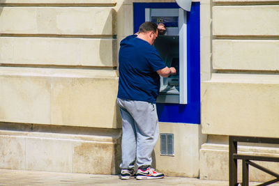 Man standing against wall