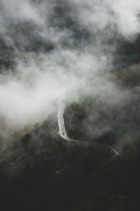 Aerial view of landscape over clouds