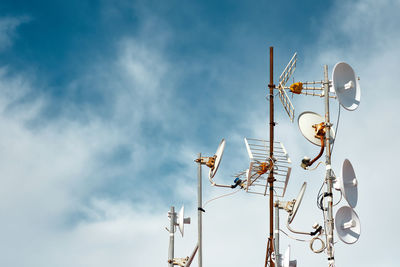 Low angle view of communications tower against sky