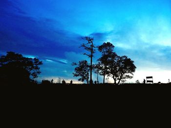 Silhouette of trees on landscape against sky